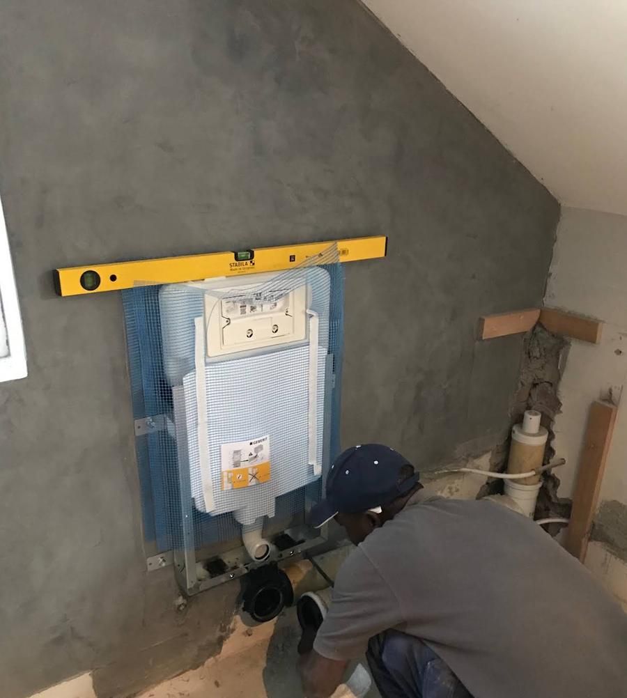 Blue Tech plumber fitting a concealed toilet cistern frame