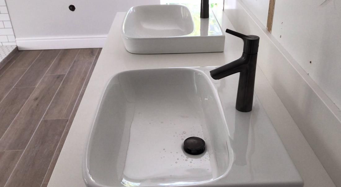 Double vanity with white basins and black mixer taps